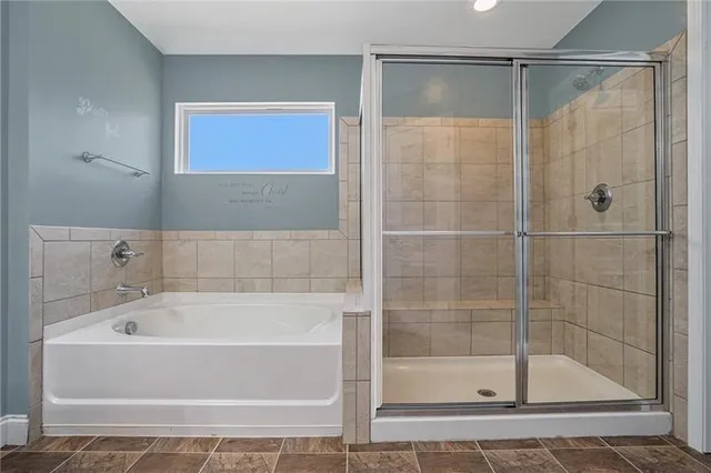 a white bath tub sitting next to a shower