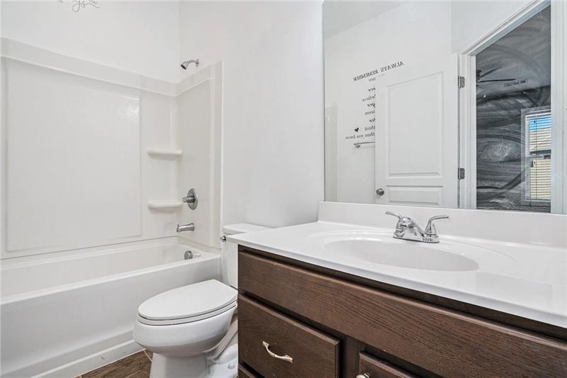 115 Floating Leaf Way Dallas, GA 30132 - Photo 25 of 49 a bathroom with a sink a toilet and a bathtub