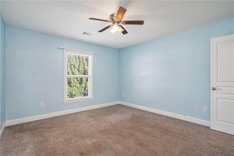 115 Floating Leaf Way Dallas, GA 30132 - Photo 26 of 49 an empty room with windows and fan