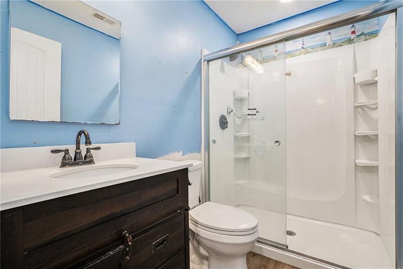 115 Floating Leaf Way Dallas, GA 30132 - Photo 39 of 49 a bathroom with a granite countertop sink toilet and shower