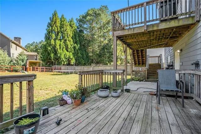 a view of a balcony with wooden floor and outdoor seating