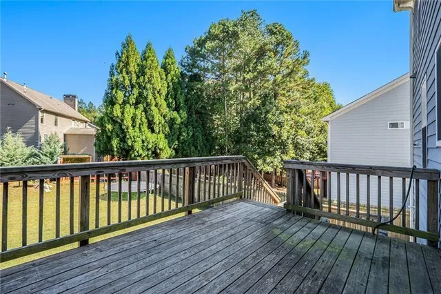 a view of balcony with wooden floor and fence