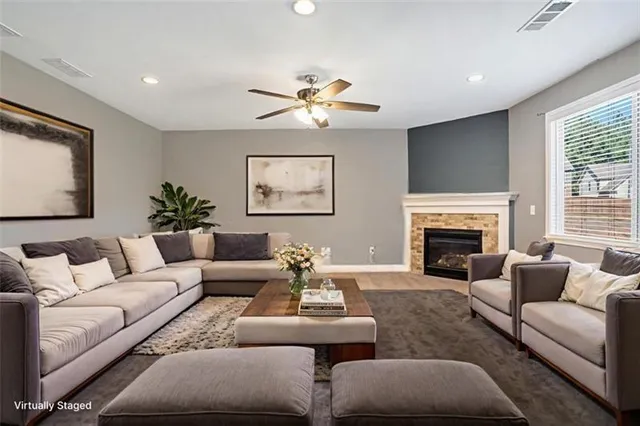 a living room with furniture and a fireplace
