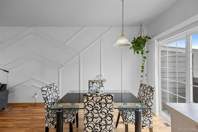 a view of a dining room with furniture and chandelier