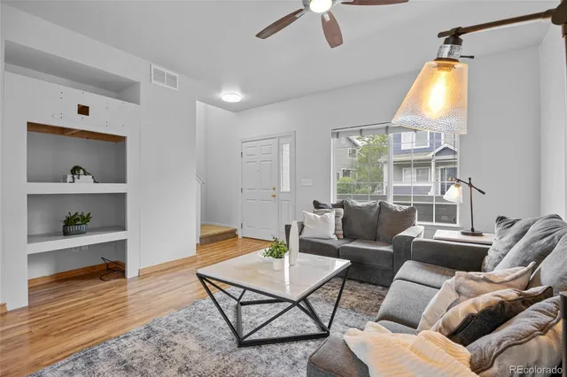 a living room with furniture a window and a flat screen tv