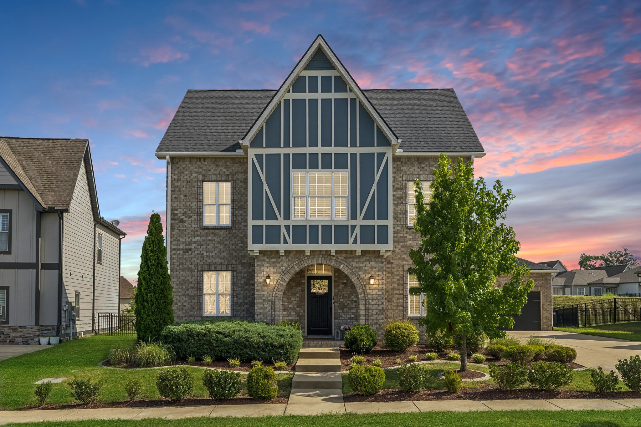 a front view of a house with a garden