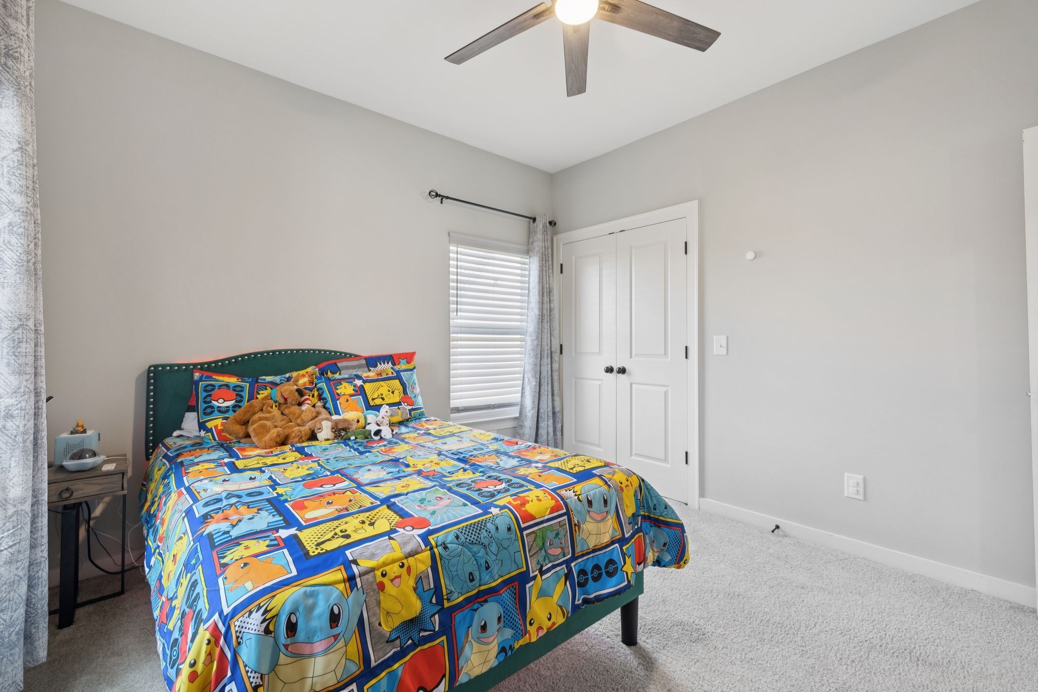 247 Croft Way Mount Juliet, TN 37122 - Photo 45 of 66 a bedroom with a bed that has a blanket and a chandelier