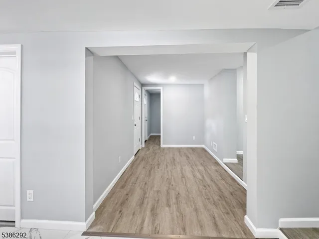 a view of hallway with wooden floor