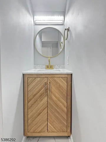 a bathroom with a sink a mirror and vanity
