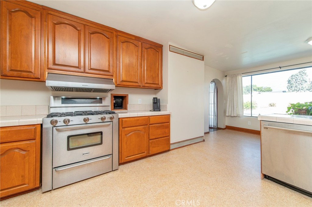 1885 West 9th Street Upland, CA 91786 - Photo 15 of 41 a kitchen with stainless steel appliances granite countertop a stove and a refrigerator
