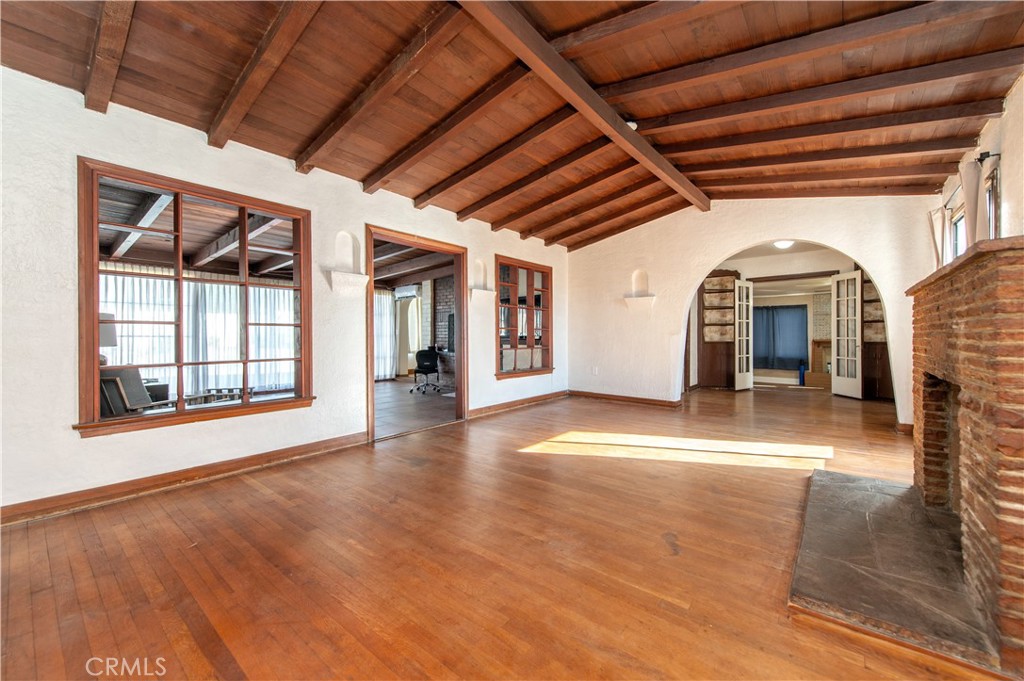1885 West 9th Street Upland, CA 91786 - Photo 8 of 41 a view of an empty room with wooden floor and a window