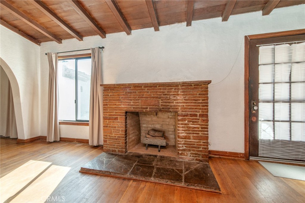 1885 West 9th Street Upland, CA 91786 - Photo 10 of 41 an empty room with wooden floor and fireplace