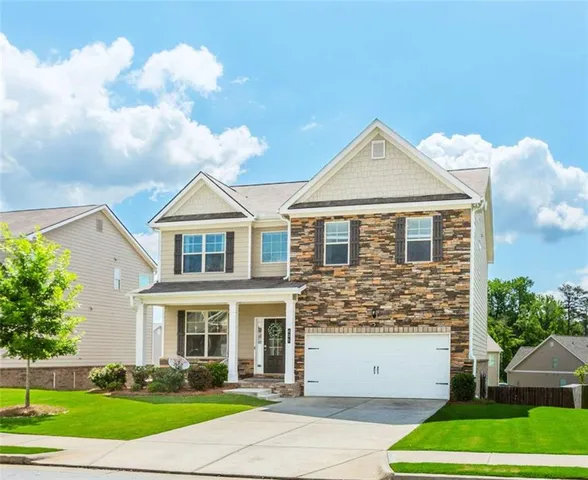 a front view of a house with a yard