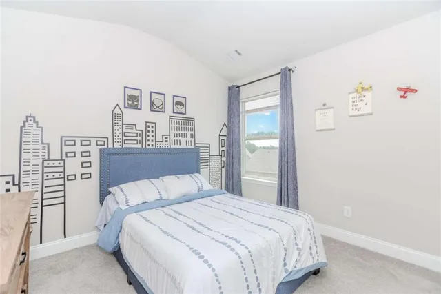 a bedroom with a bed and a night stand