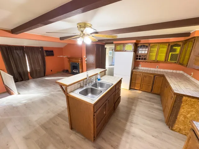 a kitchen with stainless steel appliances granite countertop a sink and a stove