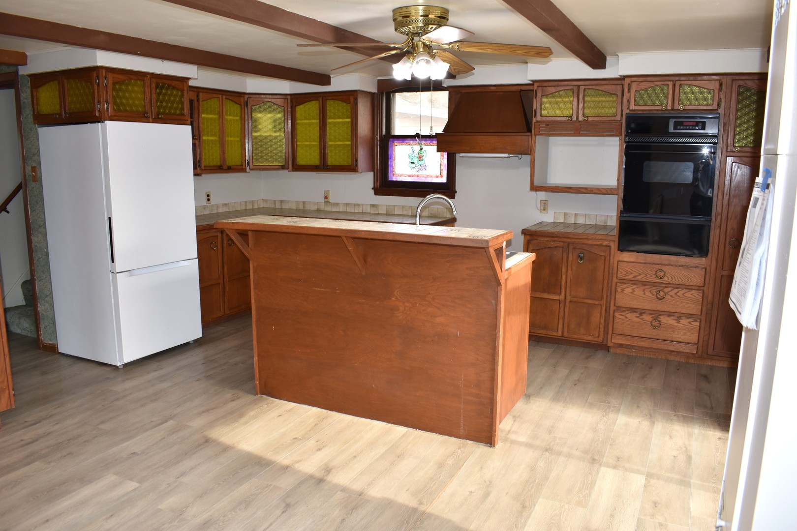 702 East Timber Street Pontiac, IL 61764 - Photo 12 of 25 a kitchen with granite countertop a refrigerator and a sink
