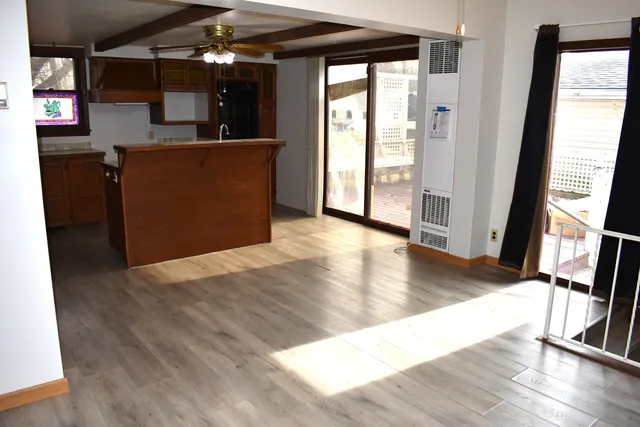 wooden floor in an empty room with a window