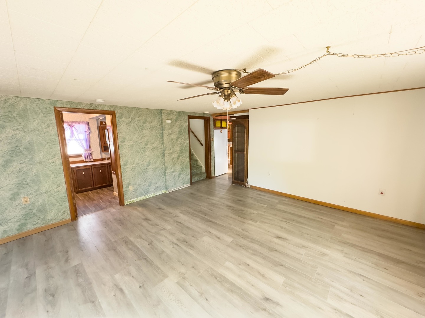702 East Timber Street Pontiac, IL 61764 - Photo 7 of 24 wooden floor in an empty room with a chandelier