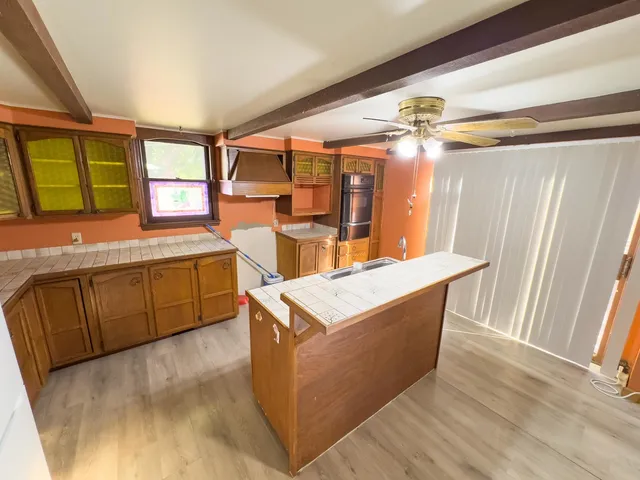 a kitchen with stainless steel appliances granite countertop a sink and a refrigerator