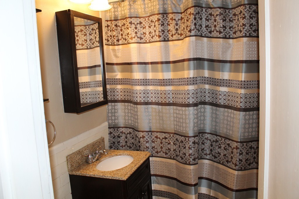 8 Walnut Street, Unit 24 Everett, MA 02149 - Photo 12 of 14 a bathroom with a sink and a mirror