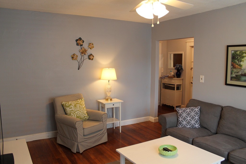 8 Walnut Street, Unit 24 Everett, MA 02149 - Photo 2 of 14 a living room with furniture and a chandelier