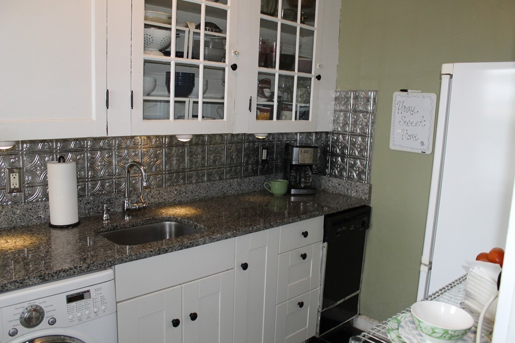 8 Walnut Street, Unit 24 Everett, MA 02149 - Photo 4 of 14 a kitchen with granite countertop a sink and a white wooden cabinets