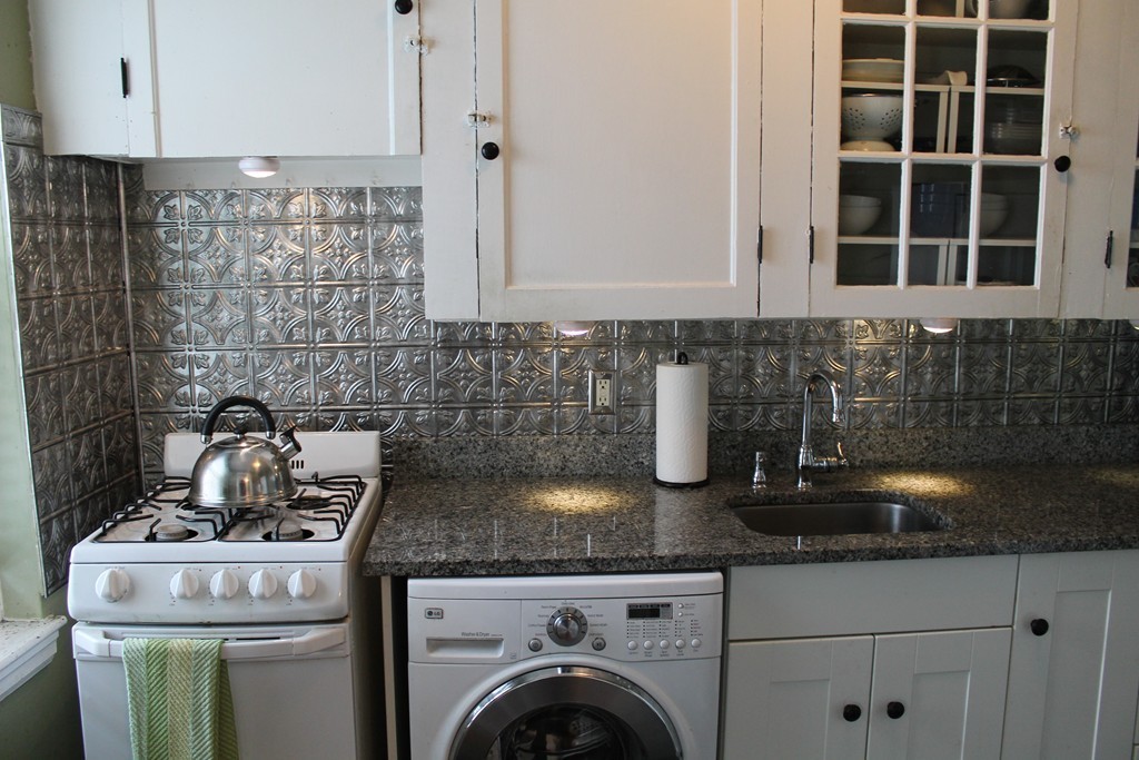 8 Walnut Street, Unit 24 Everett, MA 02149 - Photo 5 of 14 a kitchen with granite countertop a sink stove and cabinets