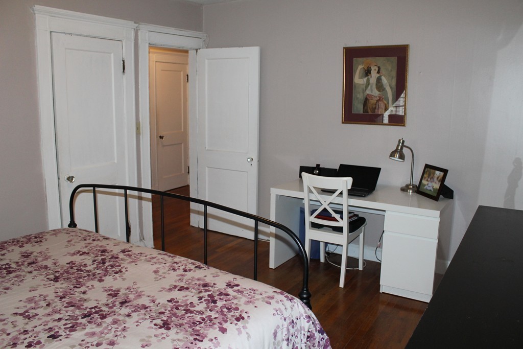 8 Walnut Street, Unit 24 Everett, MA 02149 - Photo 9 of 14 a bedroom with a bed and a dresser in it