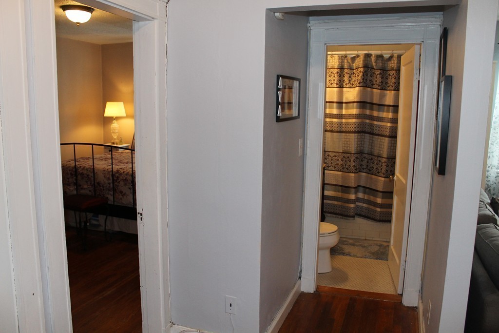 8 Walnut Street, Unit 24 Everett, MA 02149 - Photo 10 of 14 a view of a hallway with wooden floor and a bathroom