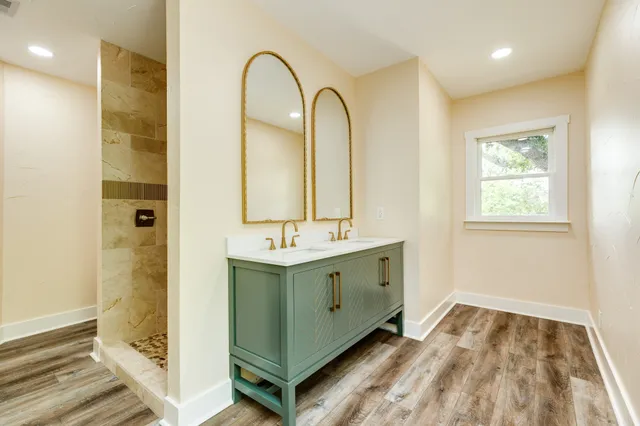 a bathroom with a double vanity sink and a mirror