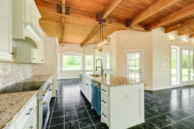 a kitchen with stainless steel appliances granite countertop a sink and cabinets