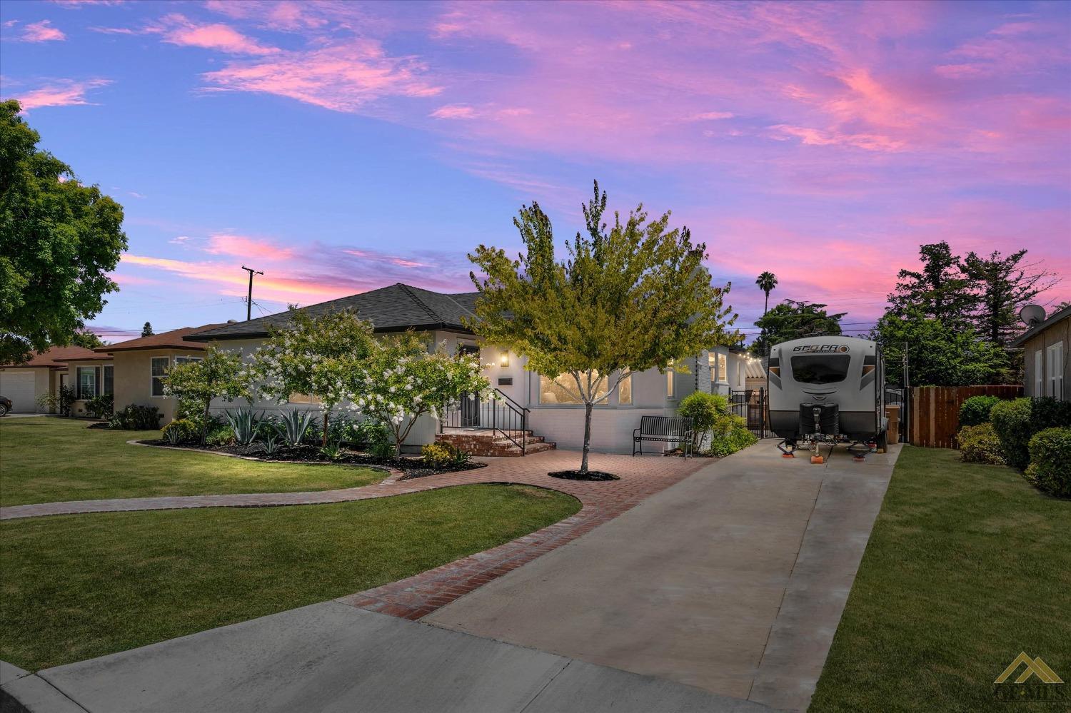 Undisclosed Address Bakersfield, CA 93305 - Photo 1 of 41 a front view of a house with a garden and a yard