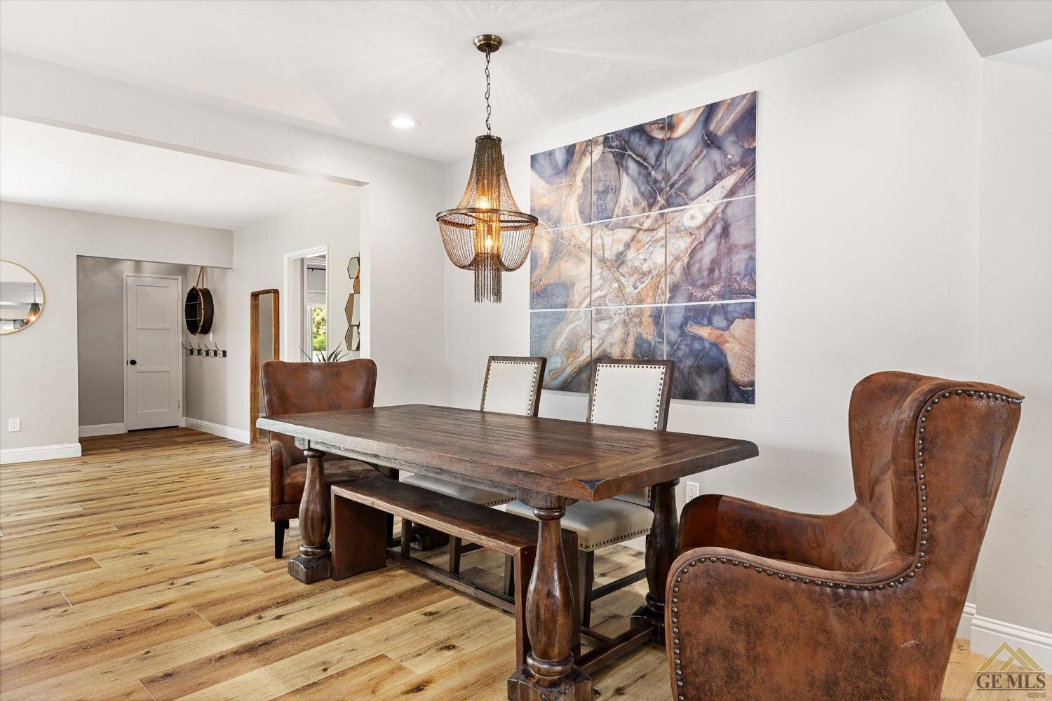 Undisclosed Address Bakersfield, CA 93305 - Photo 13 of 41 a dining room with furniture and wooden floor