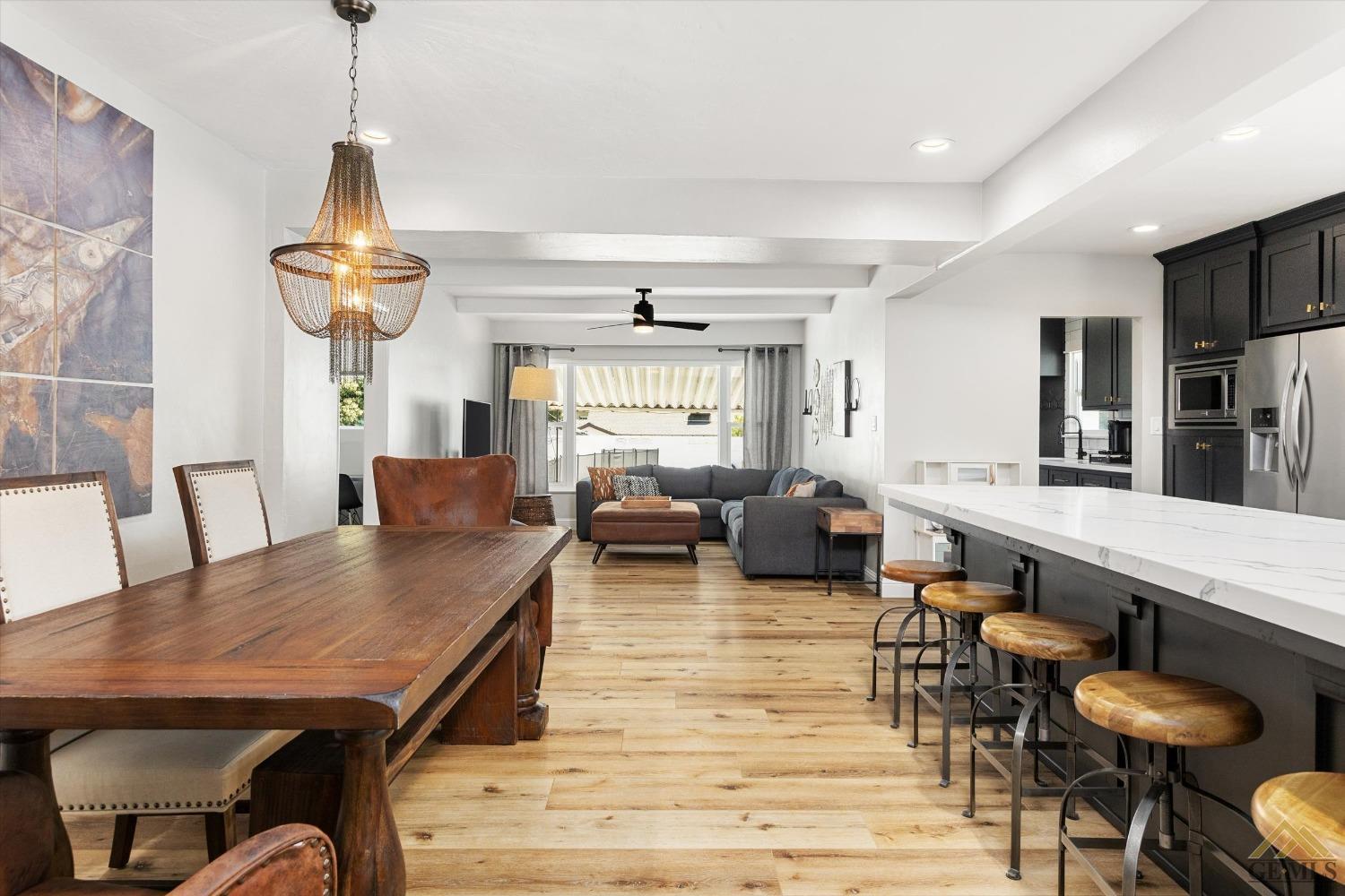 Undisclosed Address Bakersfield, CA 93305 - Photo 14 of 41 a living room with furniture a dining table and a chandelier