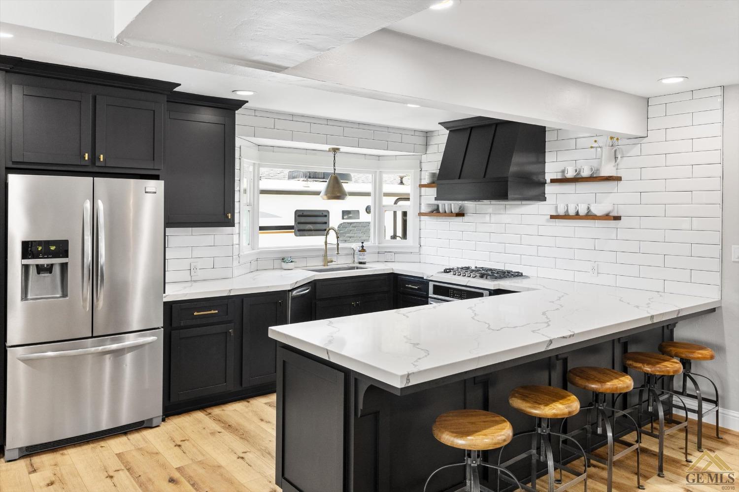 Undisclosed Address Bakersfield, CA 93305 - Photo 20 of 41 a kitchen with stainless steel appliances a sink a stove a refrigerator and cabinets