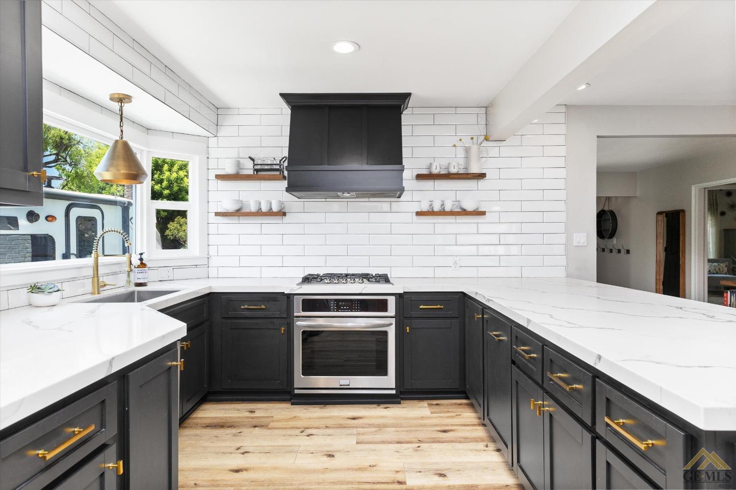 Undisclosed Address Bakersfield, CA 93305 - Photo 22 of 41 a kitchen with a sink stove and cabinets
