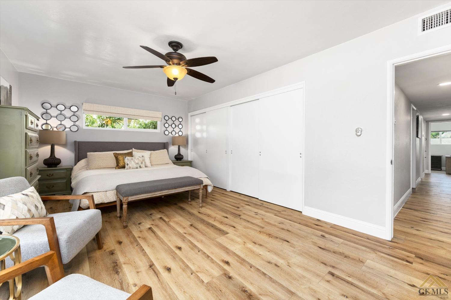 Undisclosed Address Bakersfield, CA 93305 - Photo 25 of 41 a bedroom with a bed and wooden floor