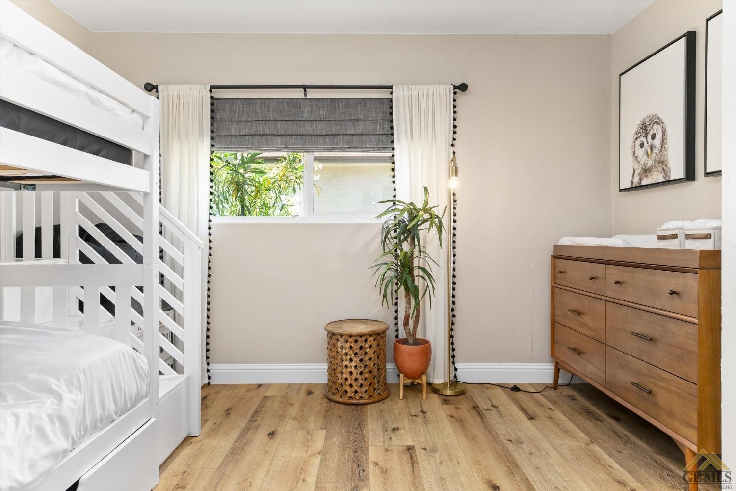 Undisclosed Address Bakersfield, CA 93305 - Photo 31 of 41 a view of bedroom with a large bed and a potted plant