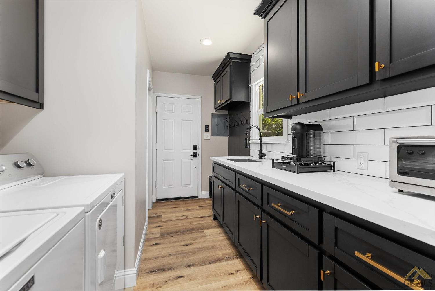 Undisclosed Address Bakersfield, CA 93305 - Photo 34 of 41 a kitchen with a sink a stove oven and cabinets