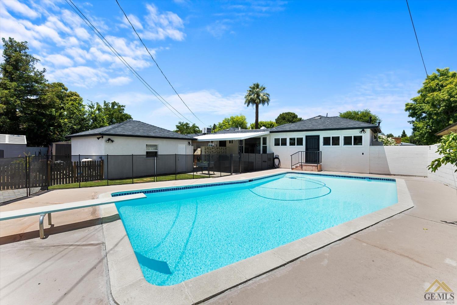 Undisclosed Address Bakersfield, CA 93305 - Photo 37 of 41 a view of a white house with a swimming pool