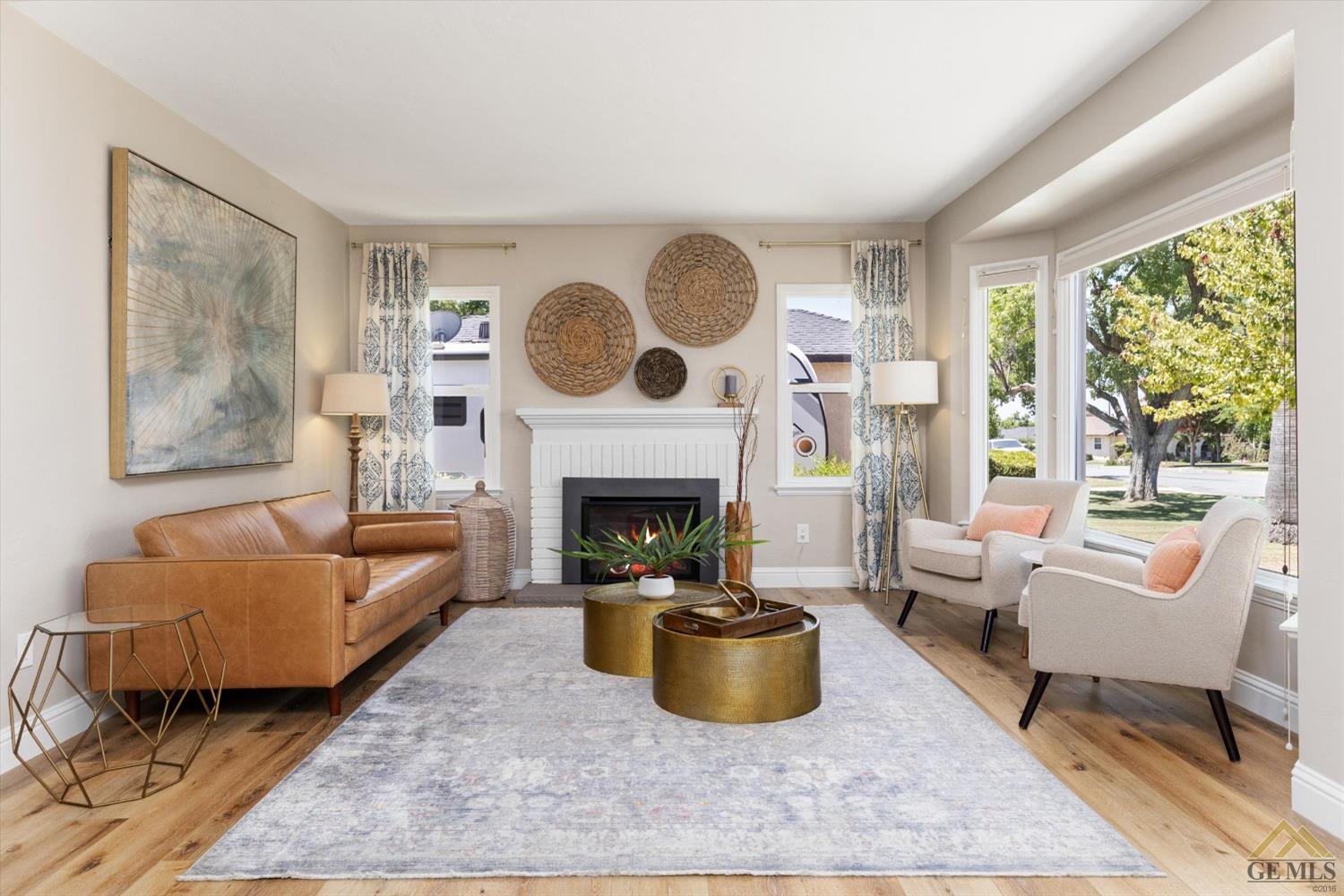 Undisclosed Address Bakersfield, CA 93305 - Photo 7 of 41 a living room with furniture a large window and a fireplace