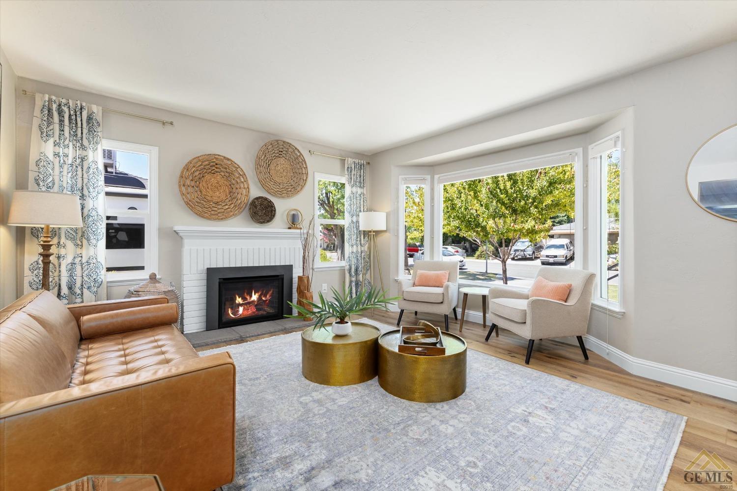 Undisclosed Address Bakersfield, CA 93305 - Photo 9 of 41 a living room with furniture a large window and a fireplace