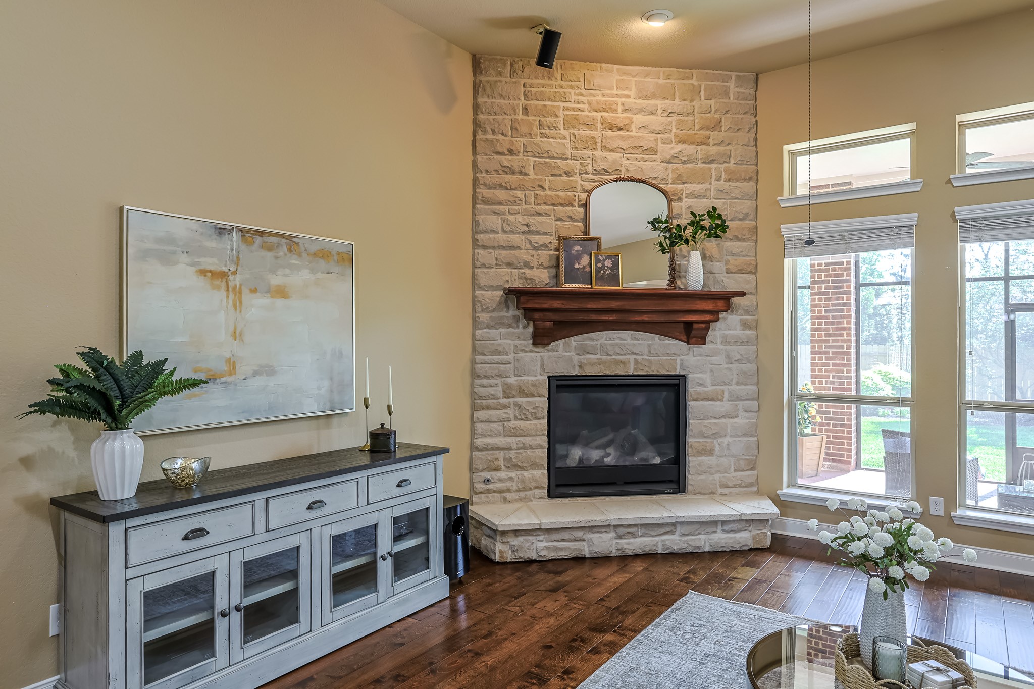 515 Mill Creek Road Pinehurst, TX 77362 - Photo 9 of 48 This inviting living room features a cozy stone fireplace with a wooden mantel and large windows for natural light.