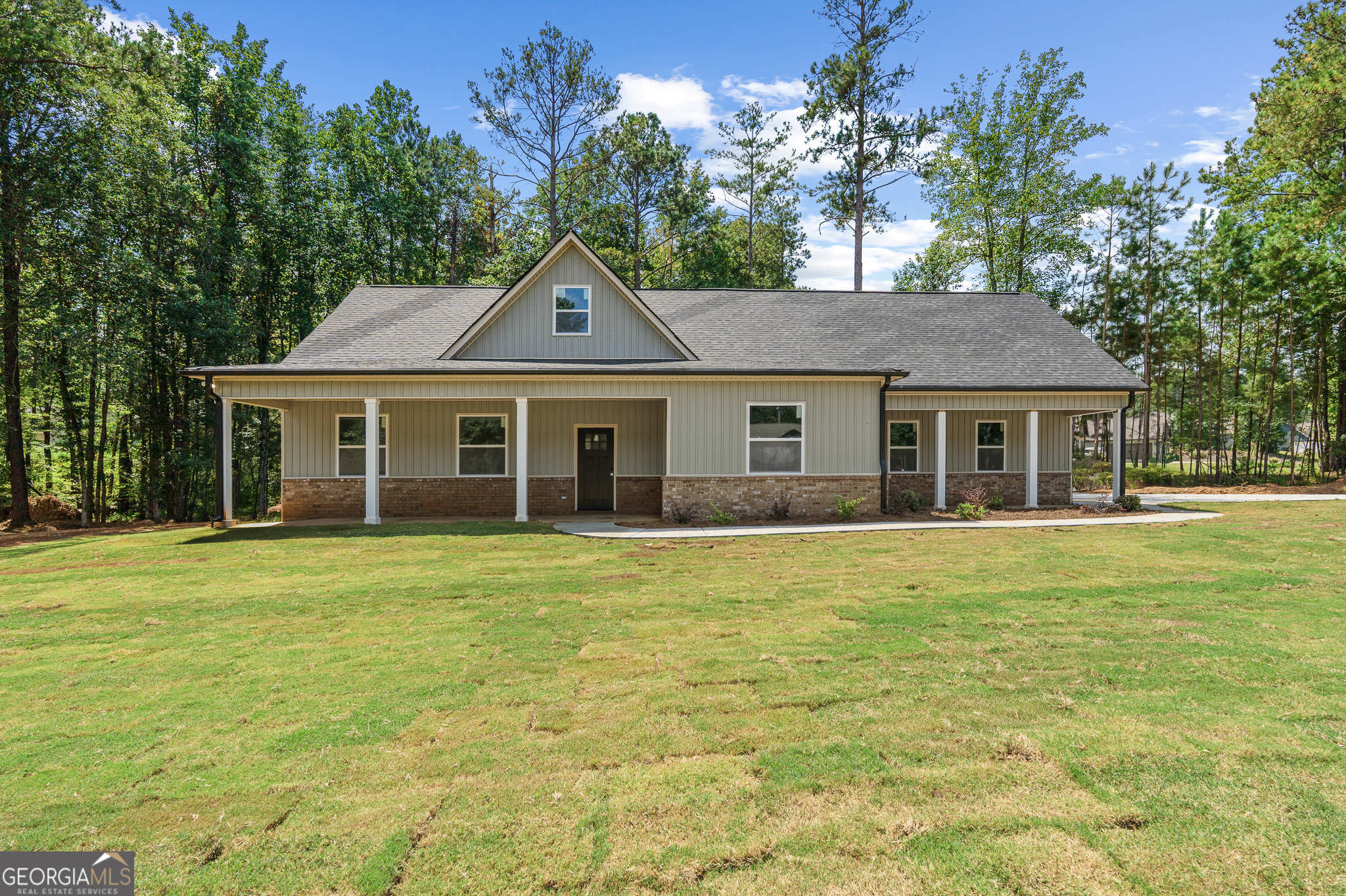 a front view of a house with a garden