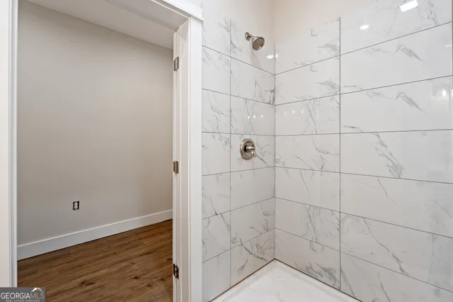 an empty room with a window and ceiling fan