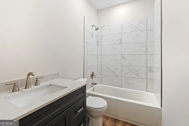 a view of a room with wooden floor and windows