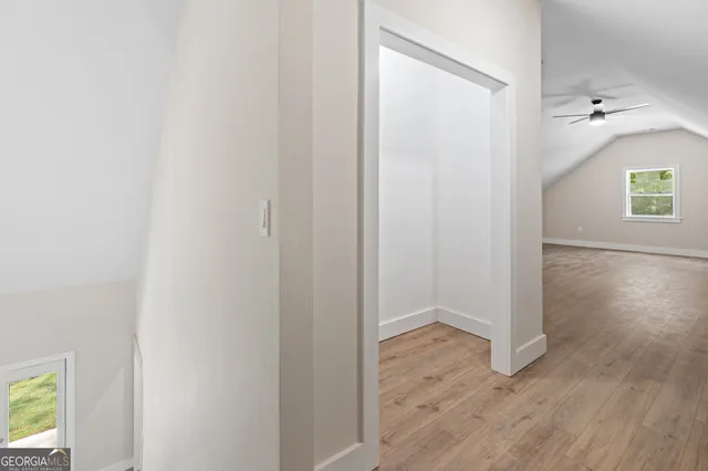 a view of a hallway with wooden floor