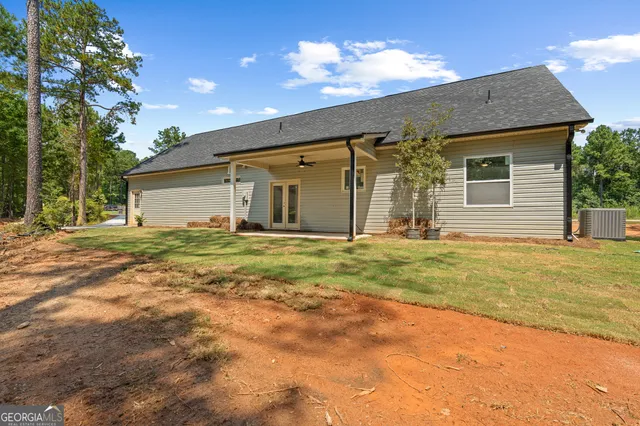 a front view of house with yard and trees