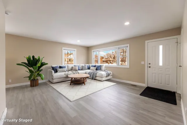 a living room with furniture and a potted plant