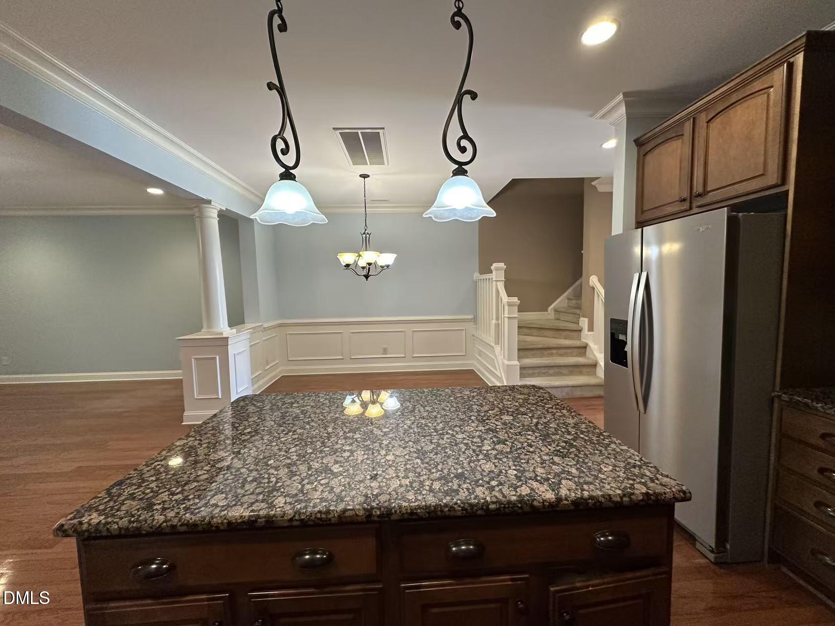 1056 Indigo Ridge Place Cary, NC 27519 - Photo 7 of 33 a view of a kitchen with a stove and a refrigerator